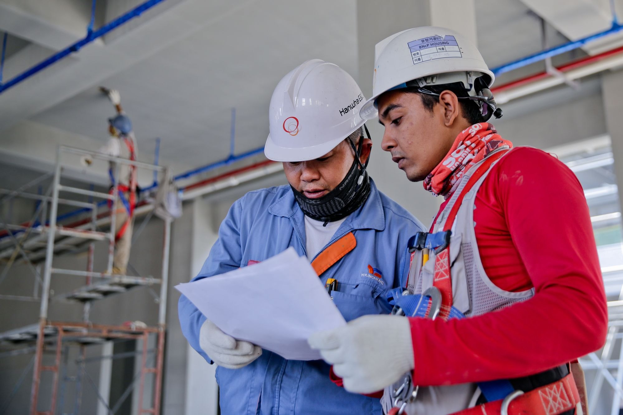 Crew reviewing blueprints on site