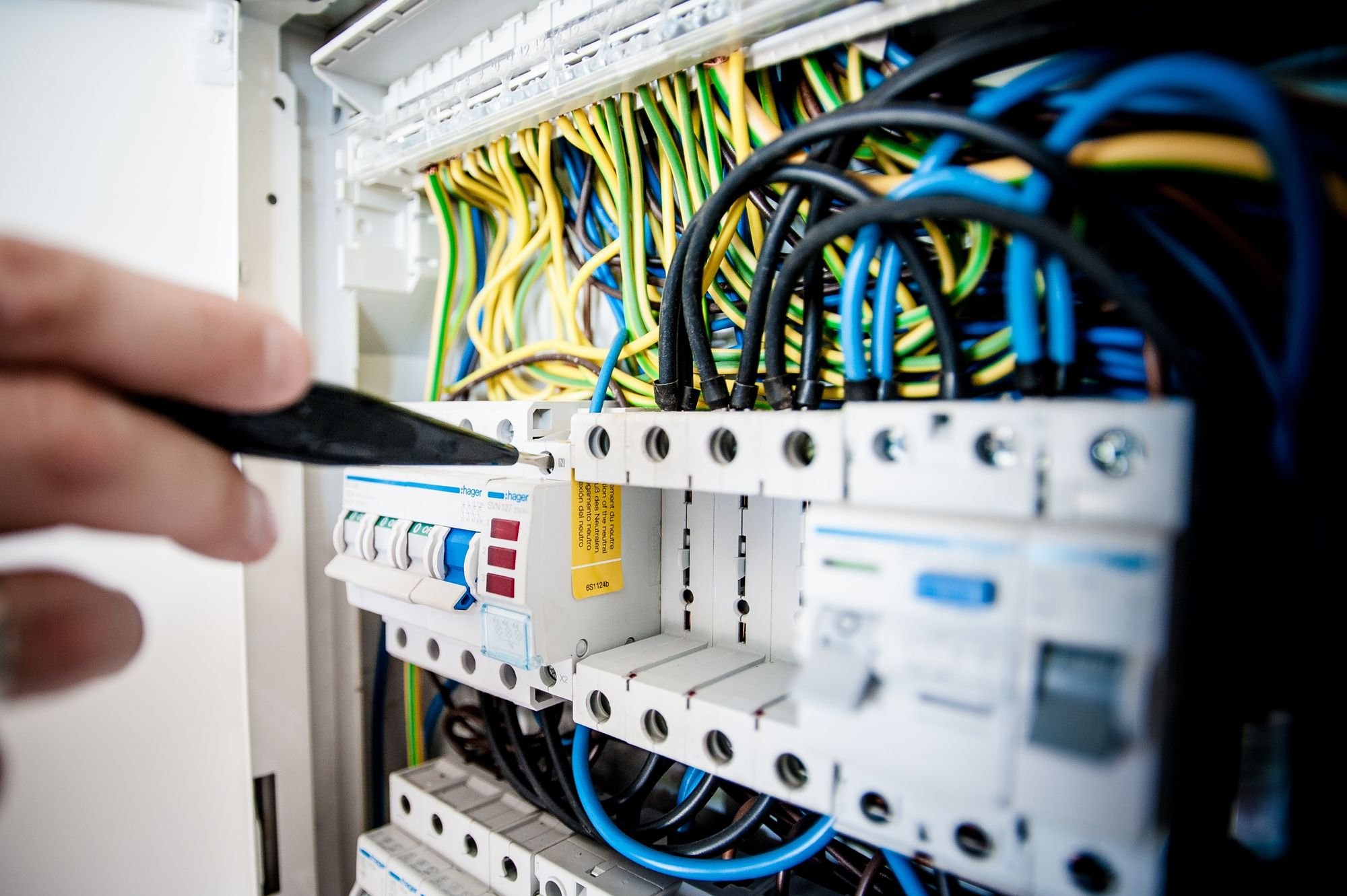 Electrician working on a breaker panel