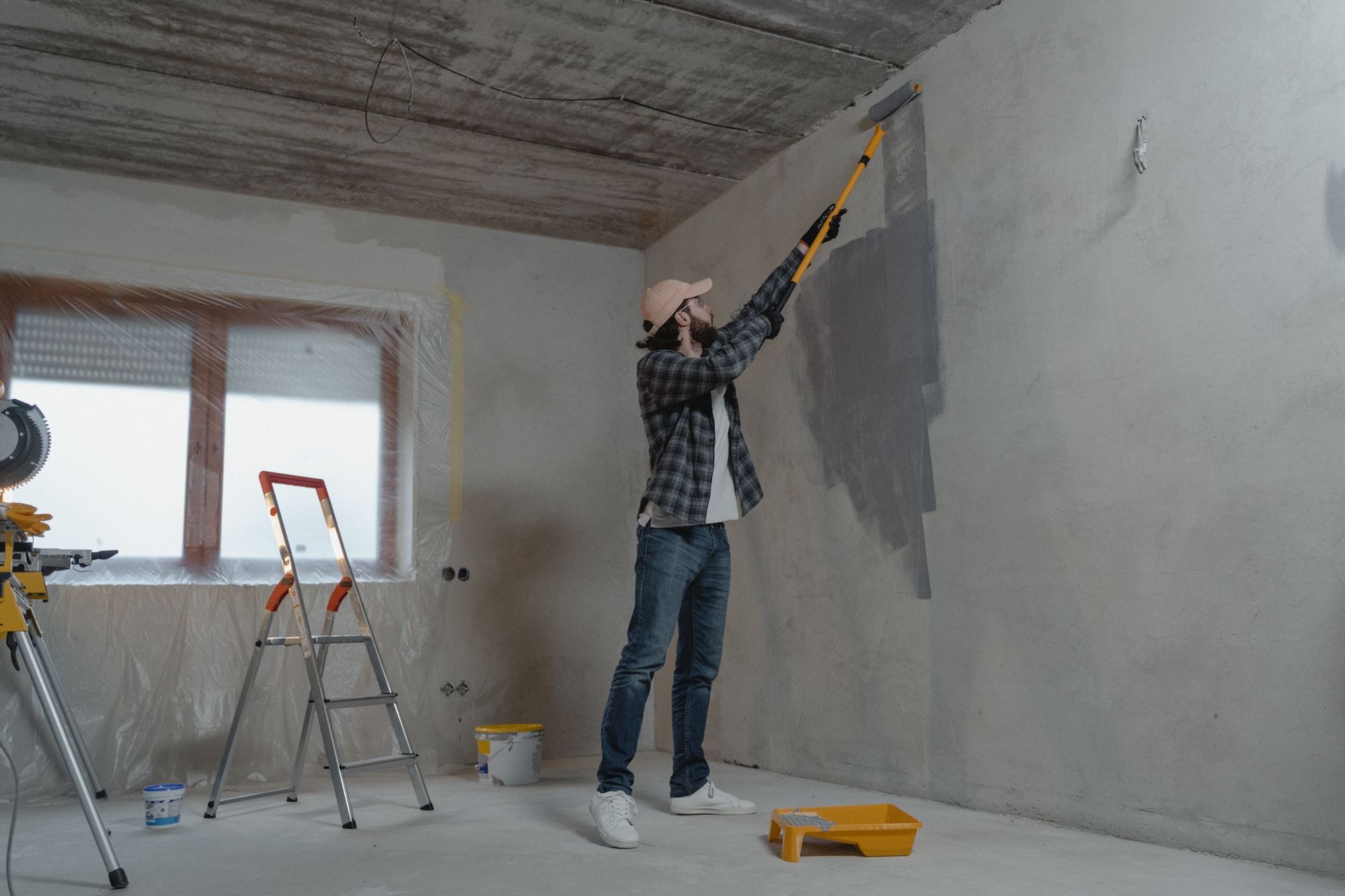 Painter rolling a wall on a renovation